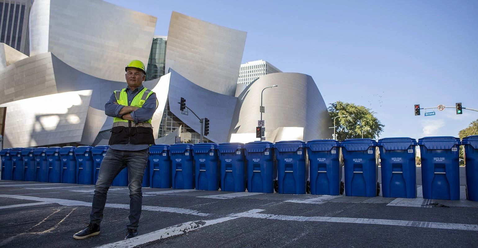 Worker in a safety vest on a Los Angeles street with the Walt Disney Concert Hall in the background